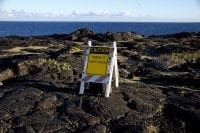 Photo of caution sign on lava flow